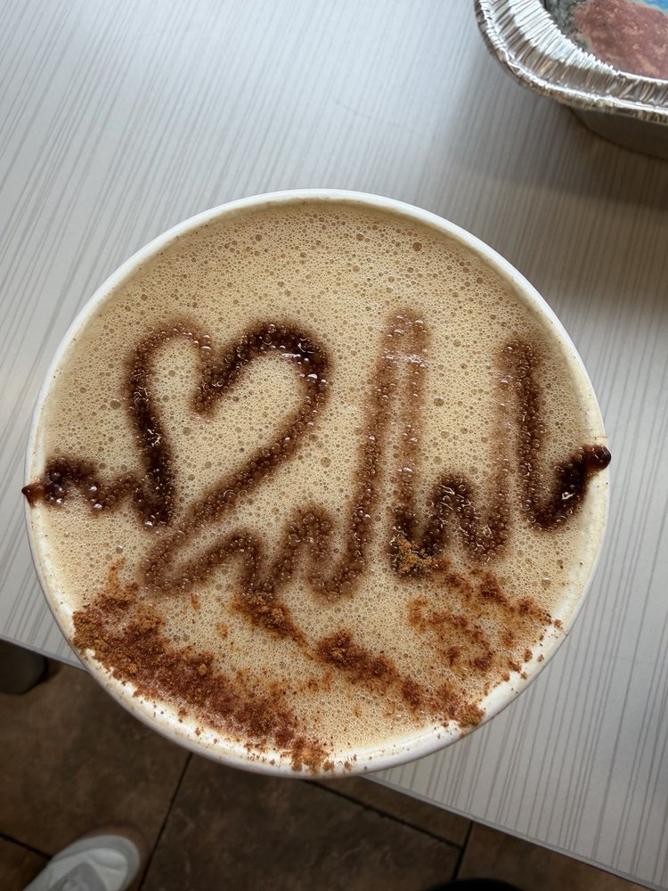 A cup of coffee with foam artwork at the cafe